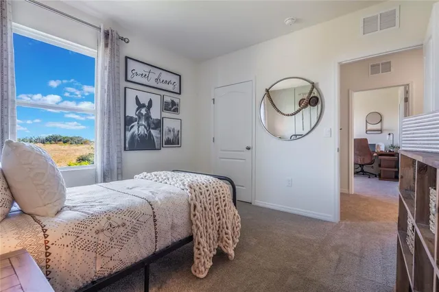 a bedroom with a bed and dresser