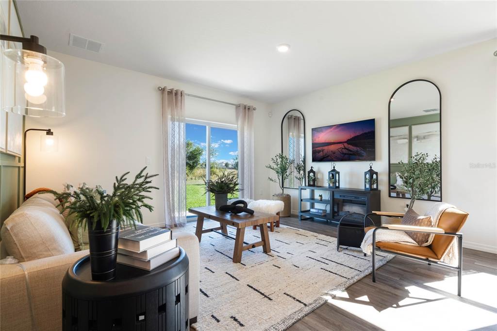 3441 Nettle Loop Tavares, FL 32778 - Photo 6 of 29 a living room with furniture potted plant and a mirror