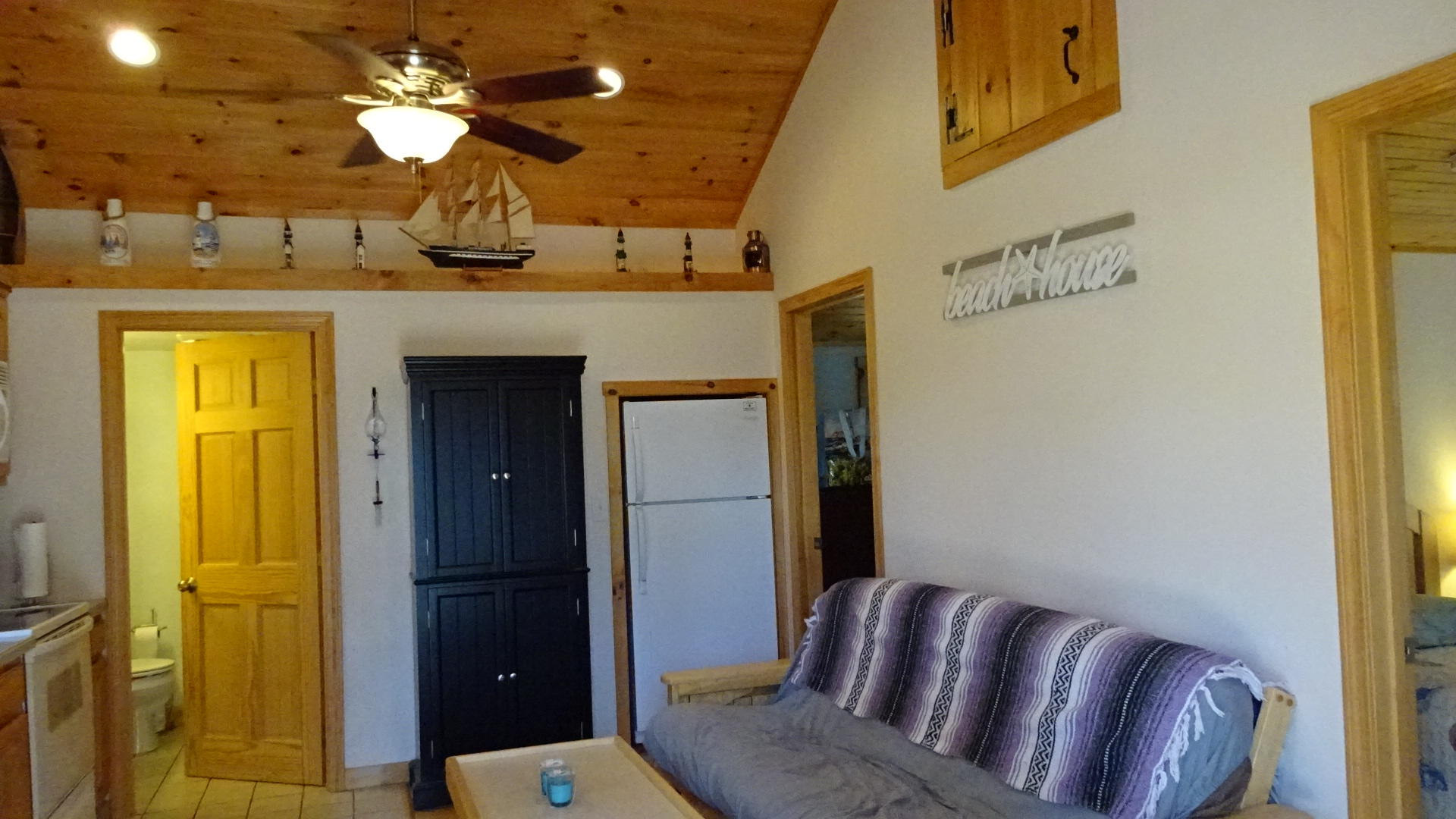 2032 State Highway Route Wellfleet, MA 02667 - Photo 11 of 33 a living room with a couch and chandelier