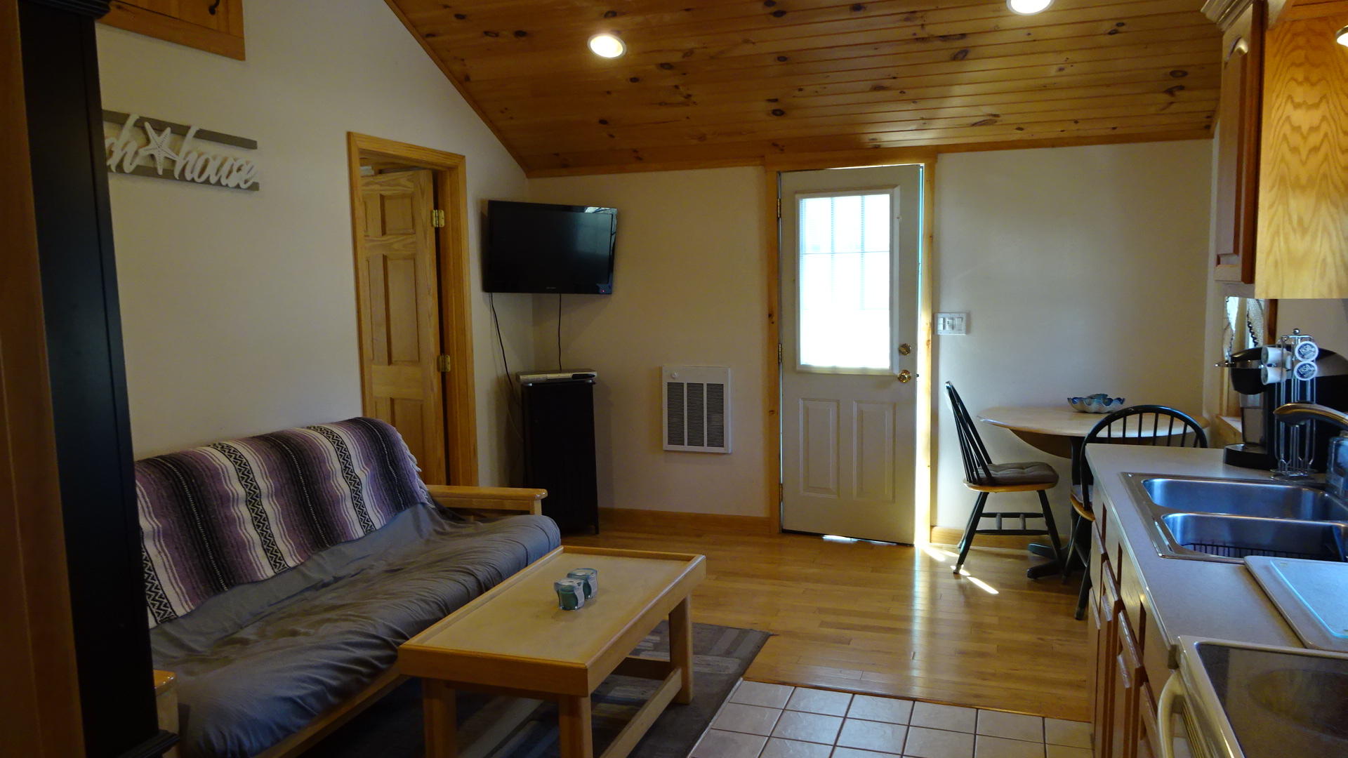 2032 State Highway Route Wellfleet, MA 02667 - Photo 6 of 33 a living room with furniture and a flat screen tv