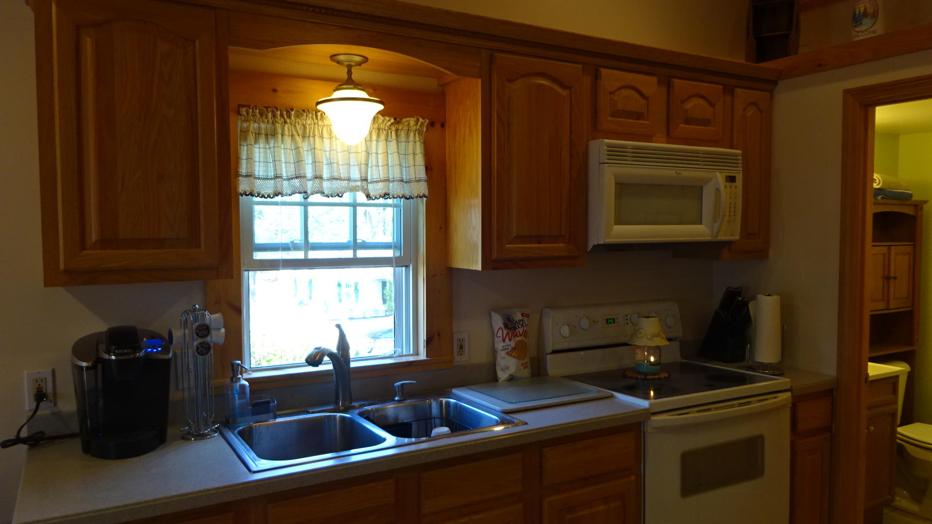 2032 State Highway Route Wellfleet, MA 02667 - Photo 9 of 33 a kitchen with a sink and cabinets