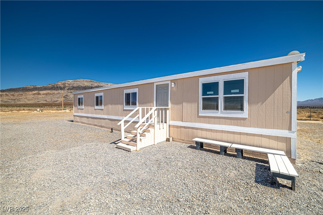 2150 West Harris Farm Road Pahrump, NV 89060 - Photo 2 of 33 Manufactured / mobile home with entry steps and a mountain view