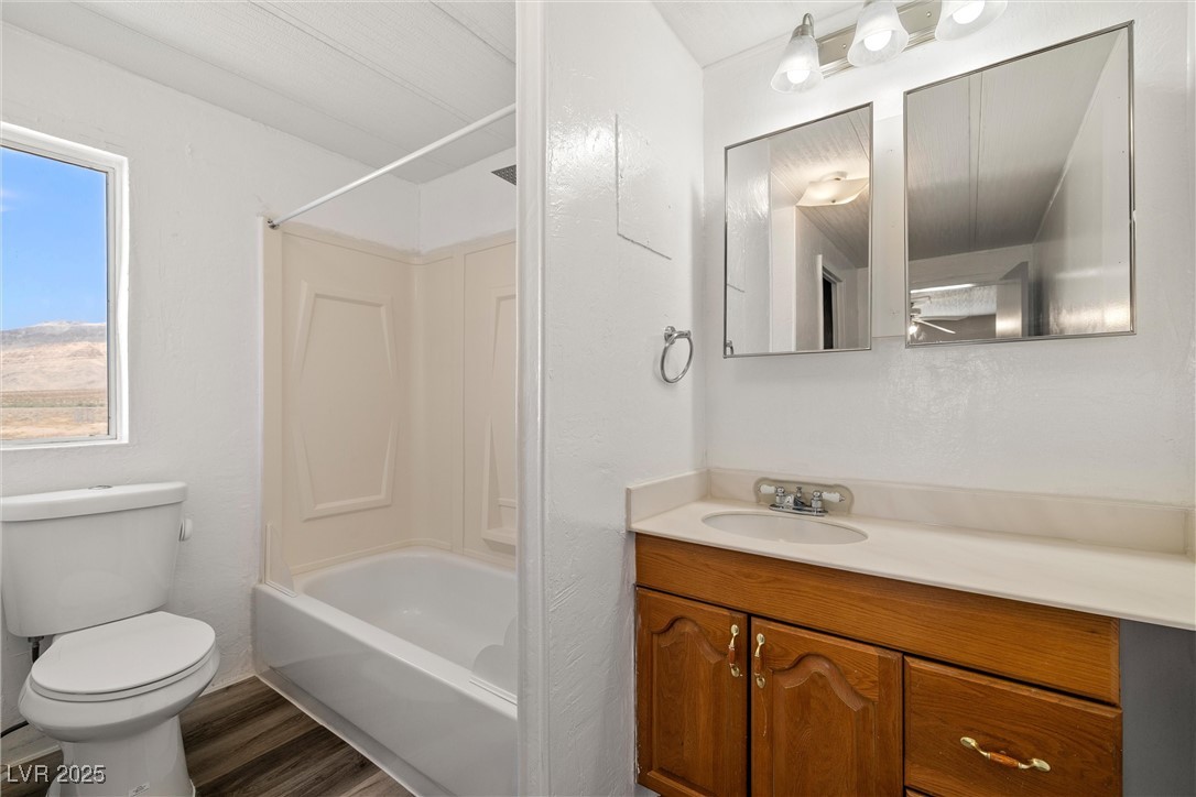 2150 West Harris Farm Road Pahrump, NV 89060 - Photo 27 of 33 Primary Bathroom with vanity, shower / bath combination, and wood finished floors