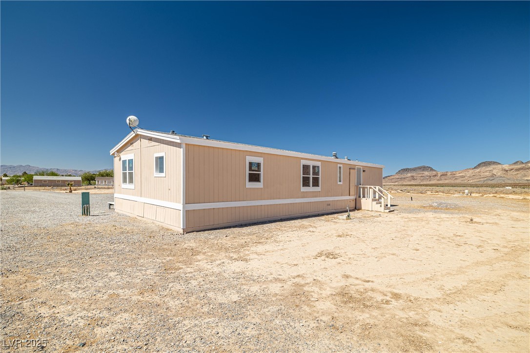 2150 West Harris Farm Road Pahrump, NV 89060 - Photo 5 of 33 Rear view of property featuring a mountain view