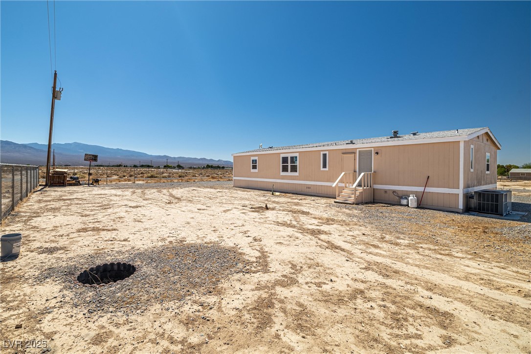 2150 West Harris Farm Road Pahrump, NV 89060 - Photo 8 of 33 Back of house featuring entry steps and a mountain view