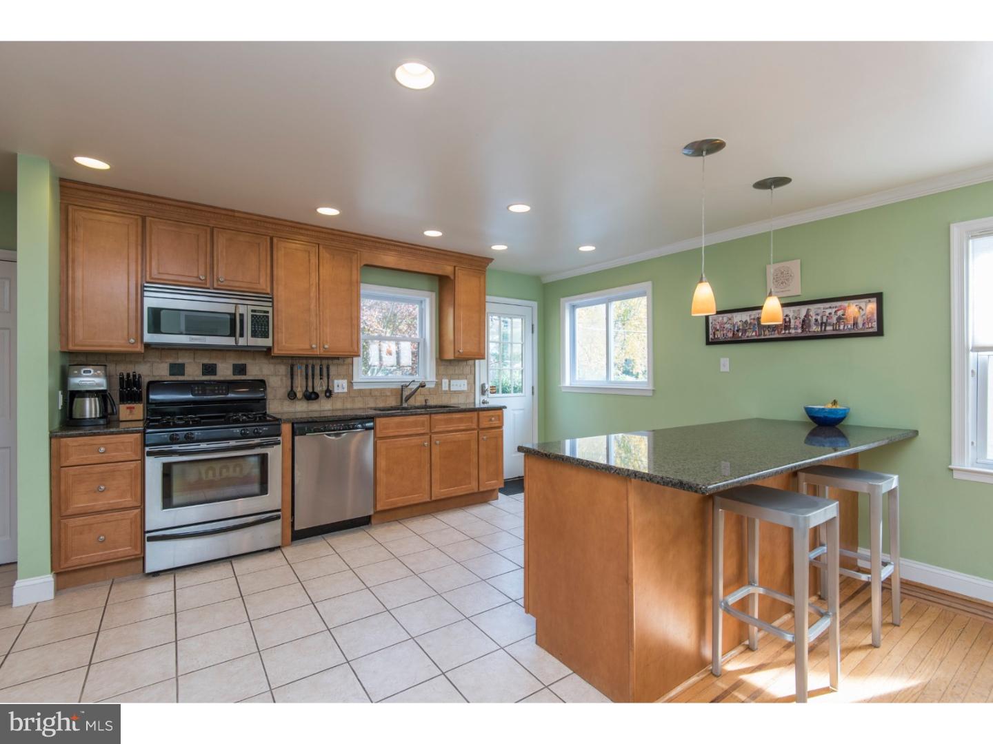 517 Valley-View Road Merion Station, PA 19066 - Photo 7 of 24 a kitchen with stainless steel appliances granite countertop a stove top oven a sink dishwasher and cabinets with wooden floor