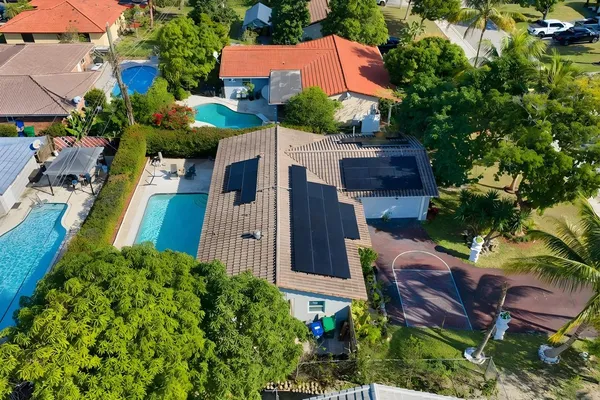 an aerial view of a house with garden space and street view