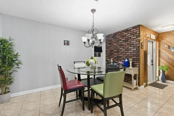 a dining room filled with furniture and chandelier
