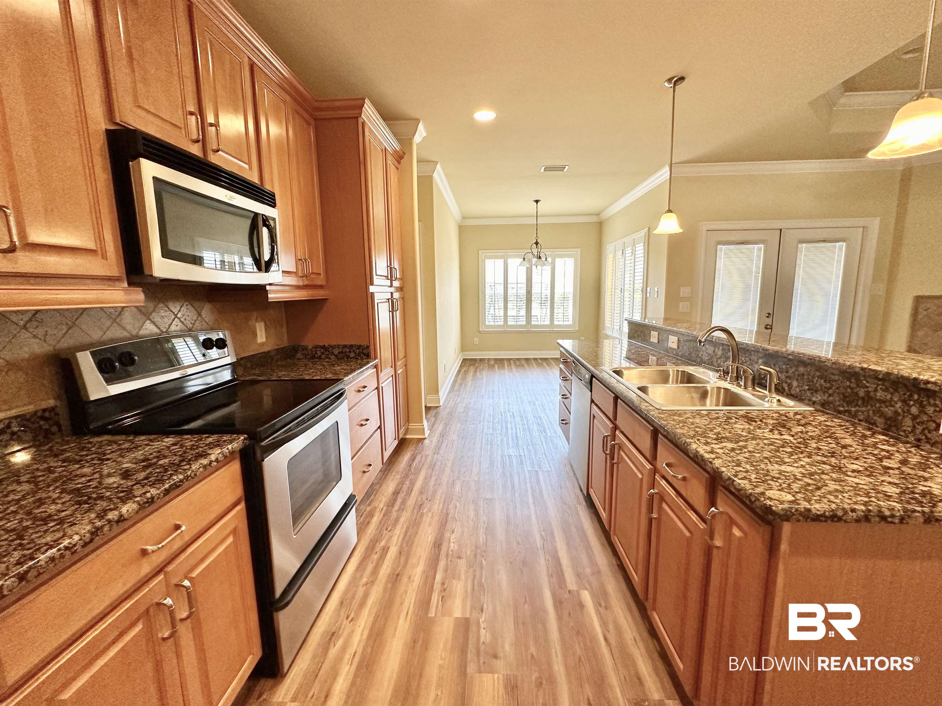 249 Hemingway Loop Foley, AL 36535 - Photo 8 of 33 Kitchen featuring decorative backsplash, appliances with stainless steel finishes, light hardwood / wood-style flooring, pendant lighting, and sink