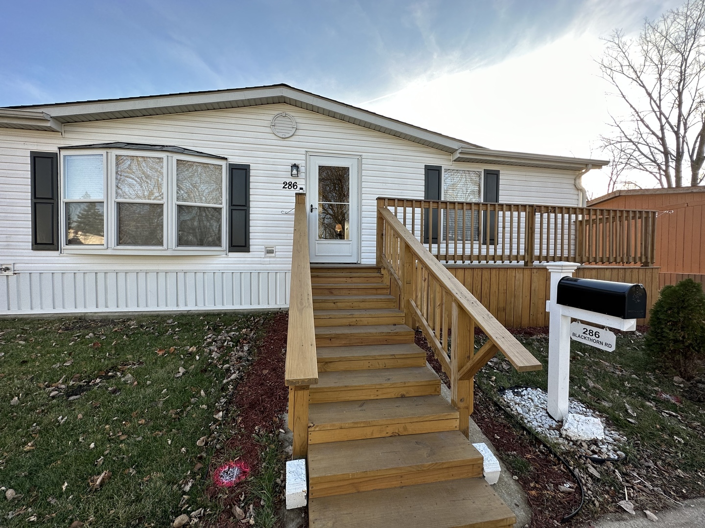 286 Blackthorn Road Matteson, IL 60443 - Photo 1 of 28 a front view of a house with wooden stairs and a porch