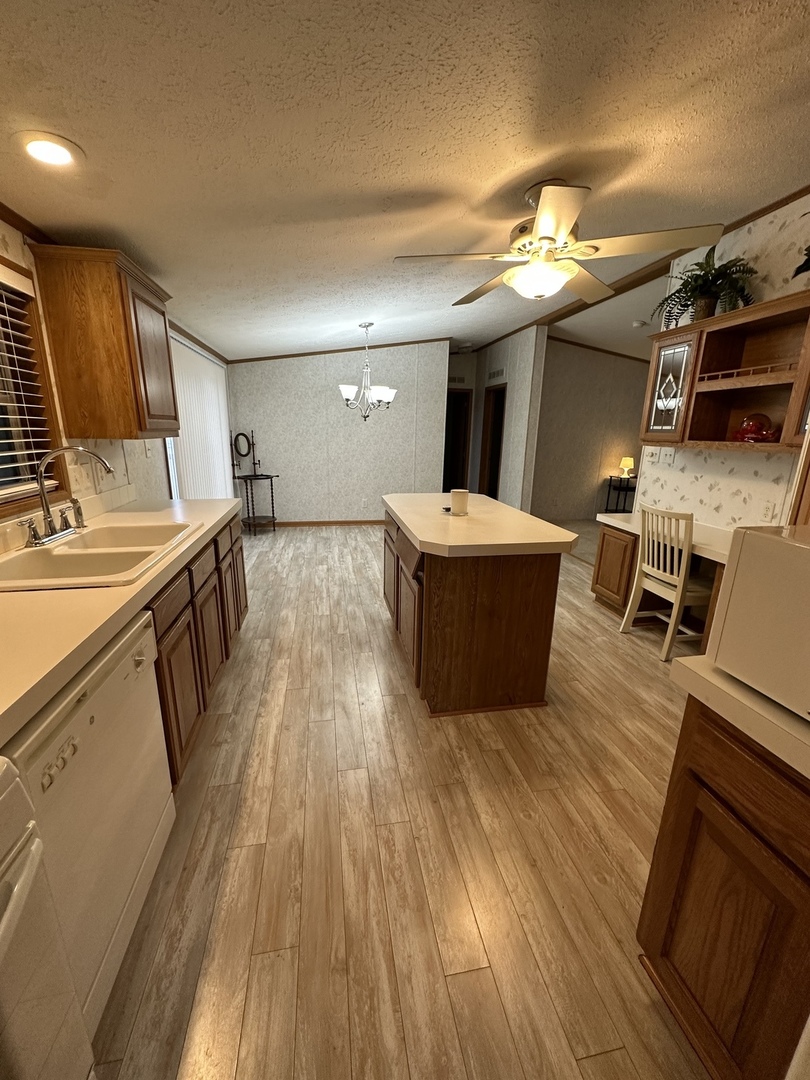 286 Blackthorn Road Matteson, IL 60443 - Photo 13 of 28 a view of a kitchen with kitchen island a counter top space a sink and wooden floor