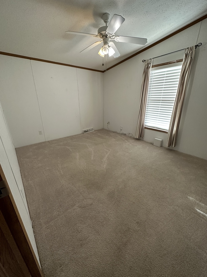 286 Blackthorn Road Matteson, IL 60443 - Photo 18 of 28 a view of a livingroom with a ceiling fan and window