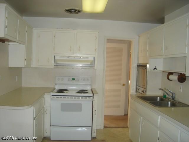 2509 Gayland Road Jacksonville, FL 32218 - Photo 7 of 8 a kitchen with a stove and a refrigerator