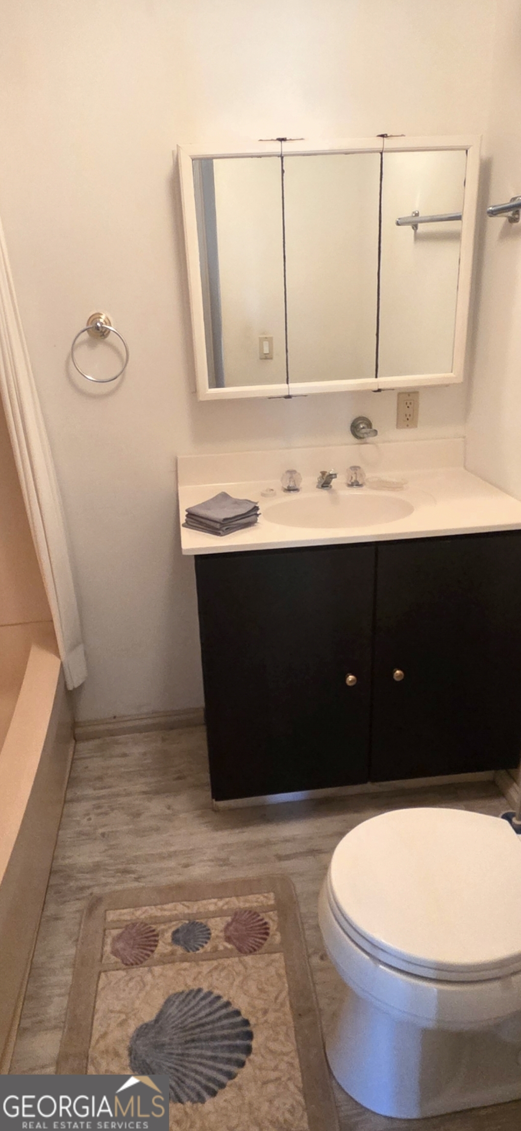 3825 North Goddard Road Lithonia, GA 30038 - Photo 24 of 36 a bathroom with a sink a toilet and mirror