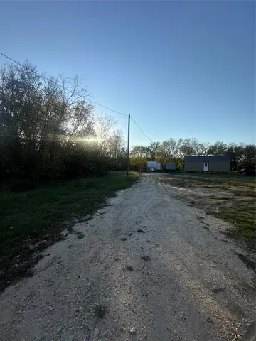 a view of a field with an trees