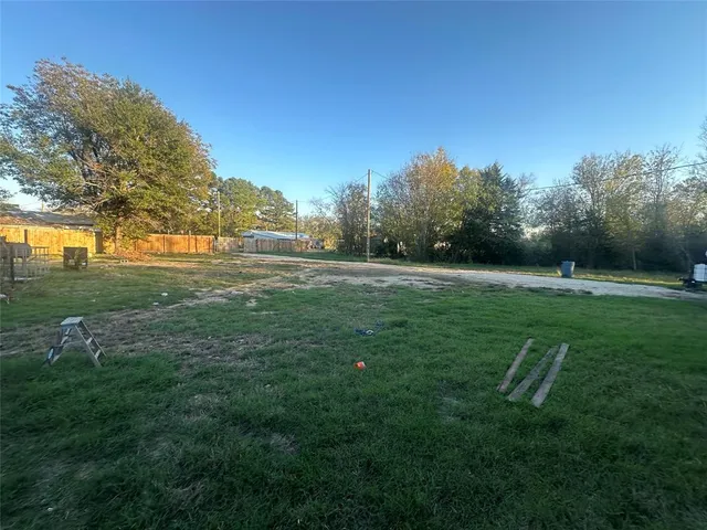 a view of a field of grass and trees