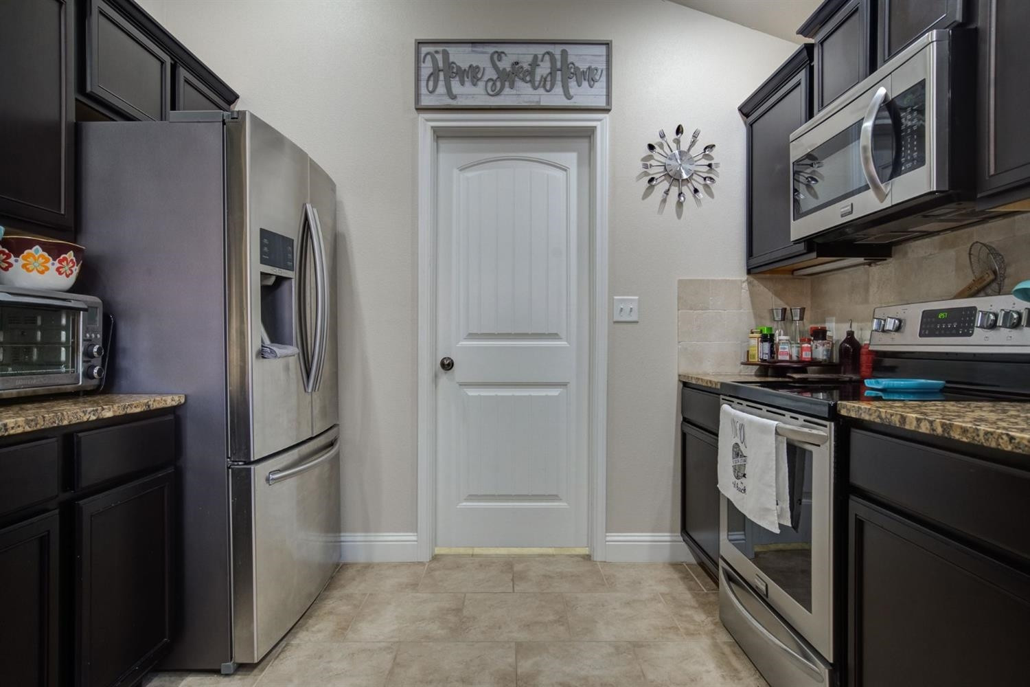 3642 Ridgely Avenue Lubbock, TX 79407 - Photo 9 of 20 a kitchen with stainless steel appliances granite countertop a refrigerator and a stove top oven