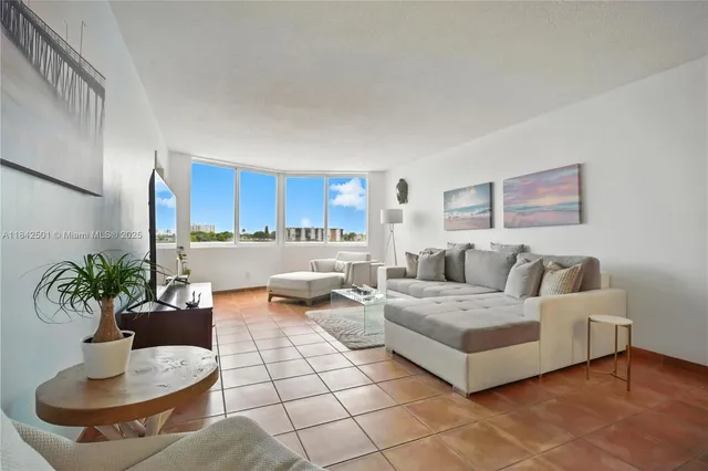a living room with furniture and a potted plant