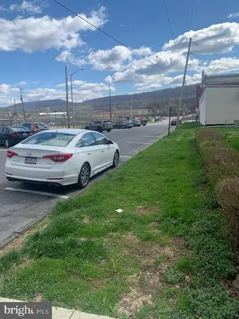 a view of a cars park in front of a house