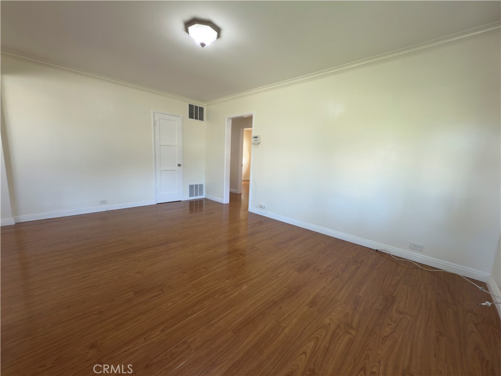 3204 Hempstead Avenue Arcadia, CA 91006 - Photo 4 of 16 an empty room with wooden floor and windows