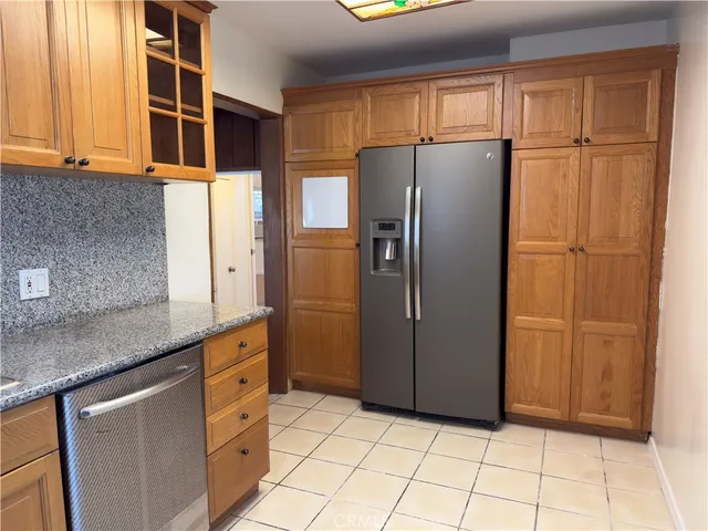 a kitchen with stainless steel appliances granite countertop a refrigerator and a sink