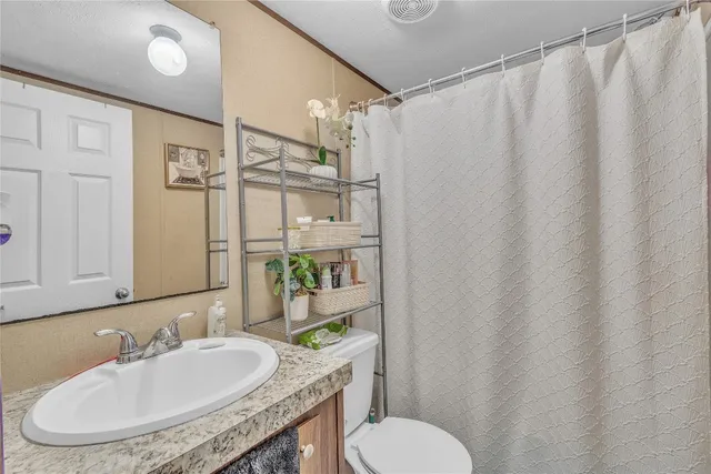 a kitchen with stainless steel appliances granite countertop a refrigerator a sink dishwasher a stove with wooden cabinets and floor