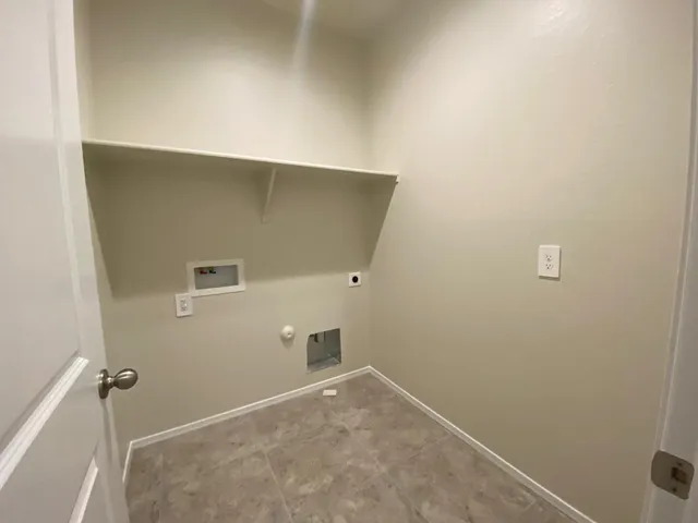 a view of an empty room with closet and a window