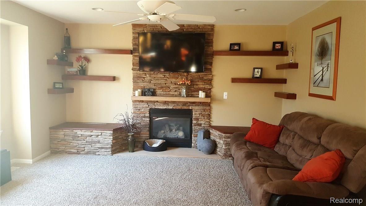 1452 Remsing Street Hartland, MI 48353 - Photo 9 of 24 Great Room on Entry Level. Stone Gas Fireplace with custom bench seating and storage.