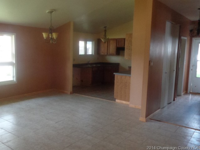 1519 Collier Avenue Rantoul, IL 61866 - Photo 6 of 15 an empty room with chandelier fan and windows