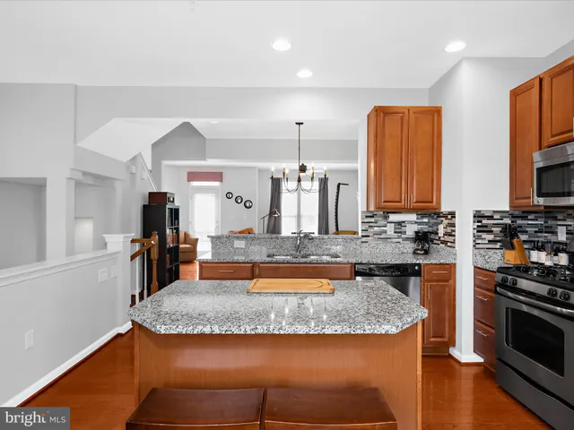 a kitchen with stainless steel appliances granite countertop a stove and a sink