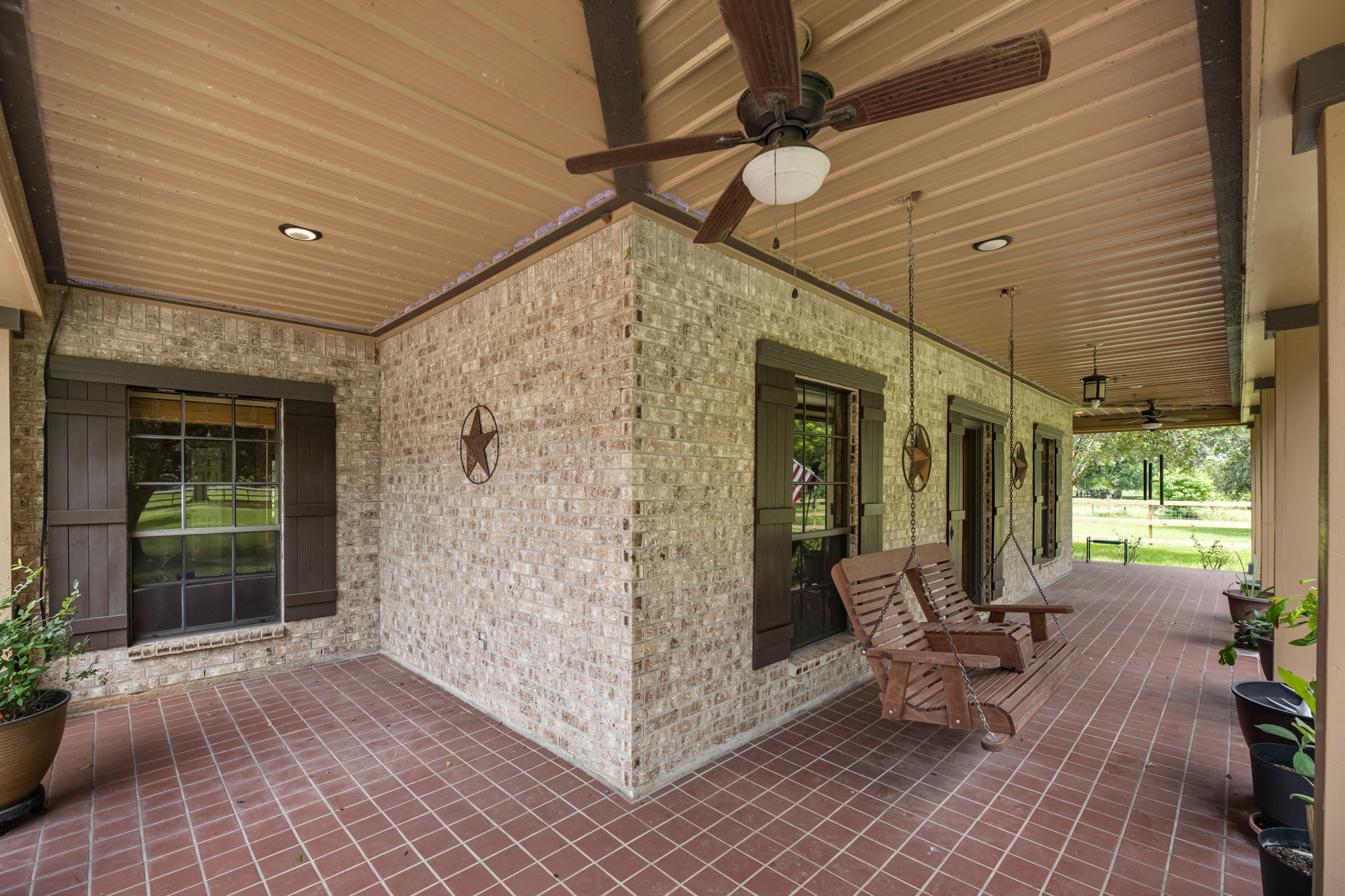 17126 County Road 39 Rosharon, TX 77583 - Photo 14 of 47 Wrap around porches are ready to add your porch swings. The metal ceilings are easily kept clean and there is led lighting highlighting them as well as recessed. Two outdoor ceiling fans to keep the air moving. Tiled.