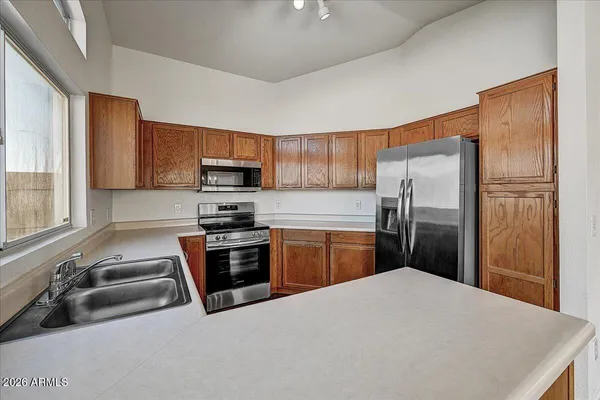 a kitchen with a refrigerator sink and microwave