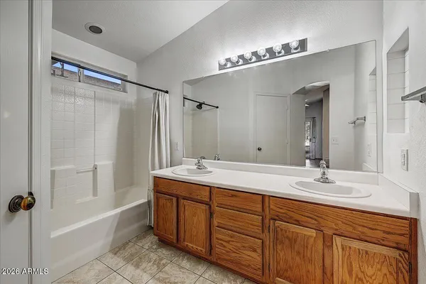 a bathroom with double vanity sinks and a mirror