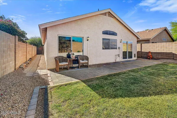 a view of a house with backyard porch and sitting area