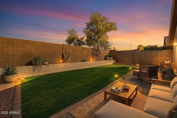 a backyard of a house with table and chairs