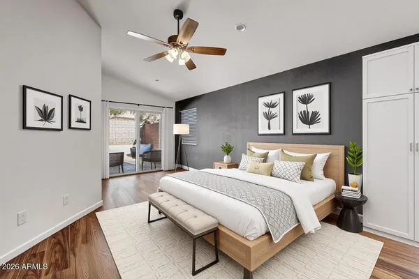 a bedroom with a large bed and a chandelier