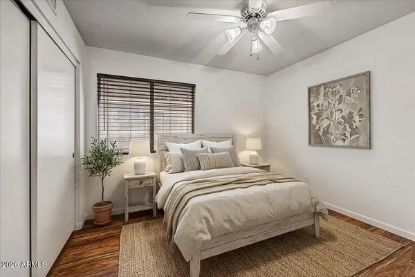a bedroom with bed and a potted plant