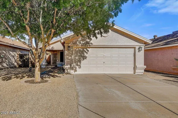 a backyard of a house with fire pit and trees