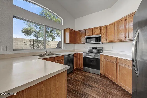 a kitchen with a stove a sink and a microwave