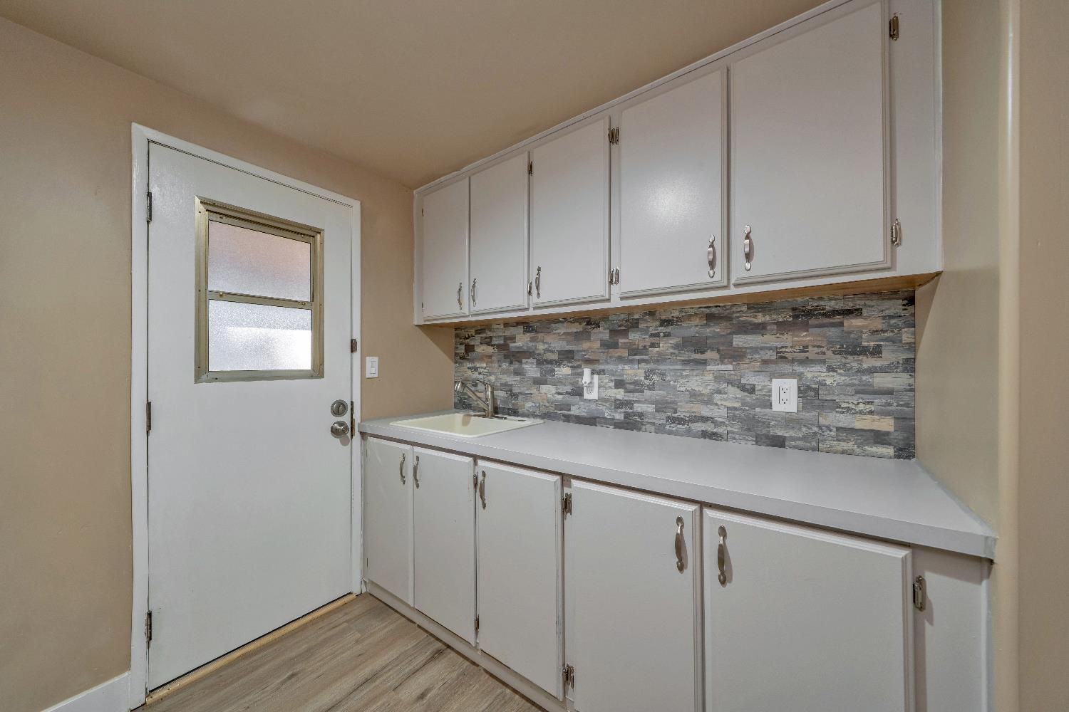 4420 Pleasant Valley Road, Unit 155 Diamond Springs, CA 95619 - Photo 34 of 42 a kitchen with granite countertop white cabinets and sink