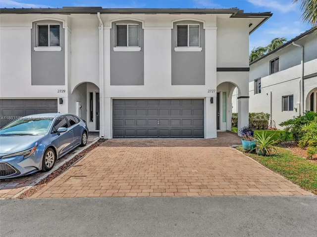 a bathroom with a granite countertop toilet and sink