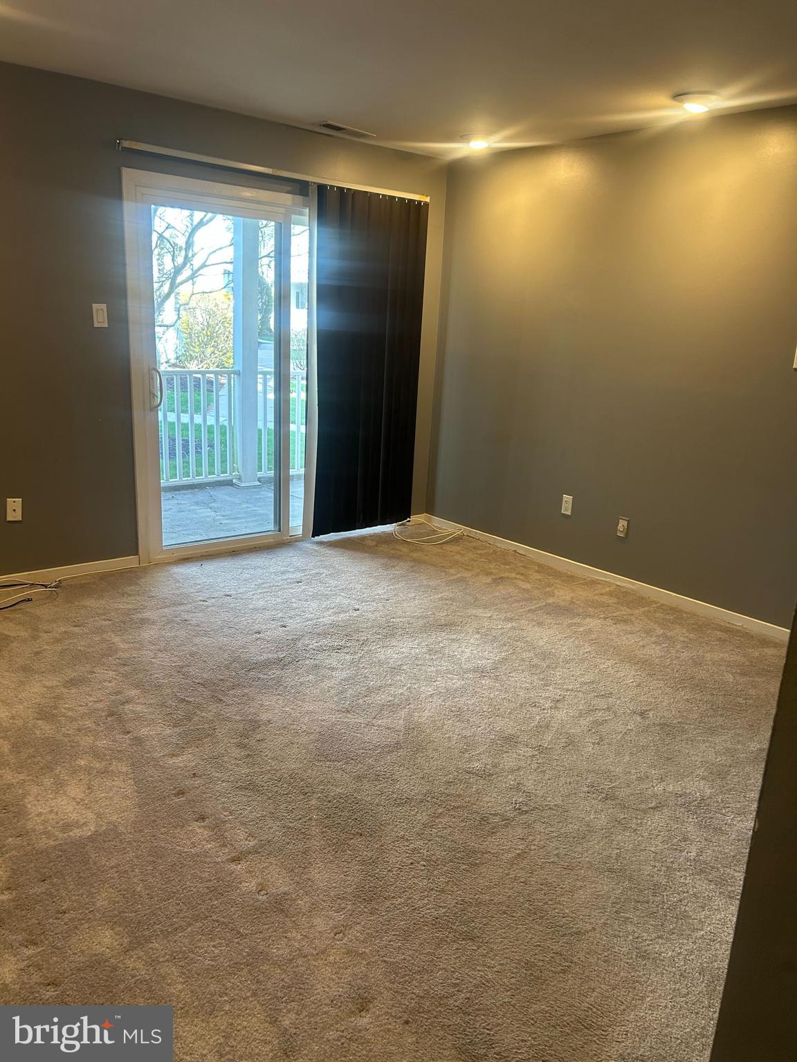 413 Gregorys Way Voorhees, NJ 08043 - Photo 7 of 11 a view of an empty room with a balcony