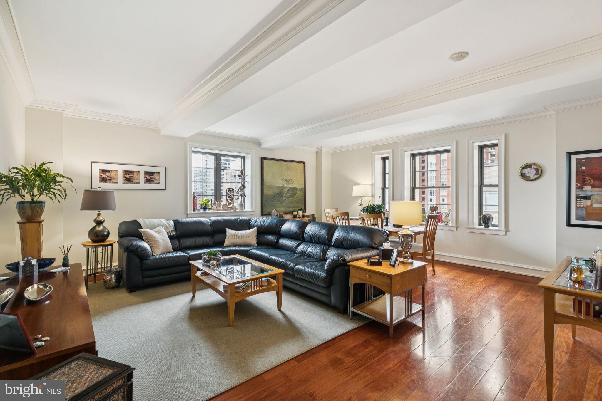 a living room with furniture a wooden floor and a window