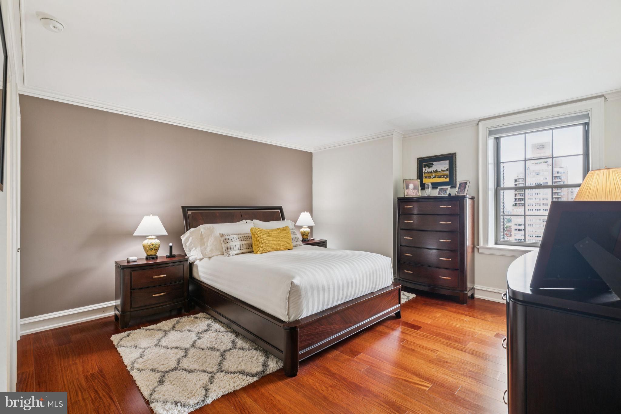 219 South 18th Street, Unit 1506 Philadelphia, PA 19103 - Photo 11 of 28 a bedroom with a bed and wooden floor