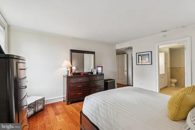 a bedroom with a bed and a dresser