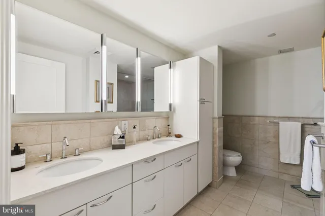 a bathroom with a double vanity sink and a mirror
