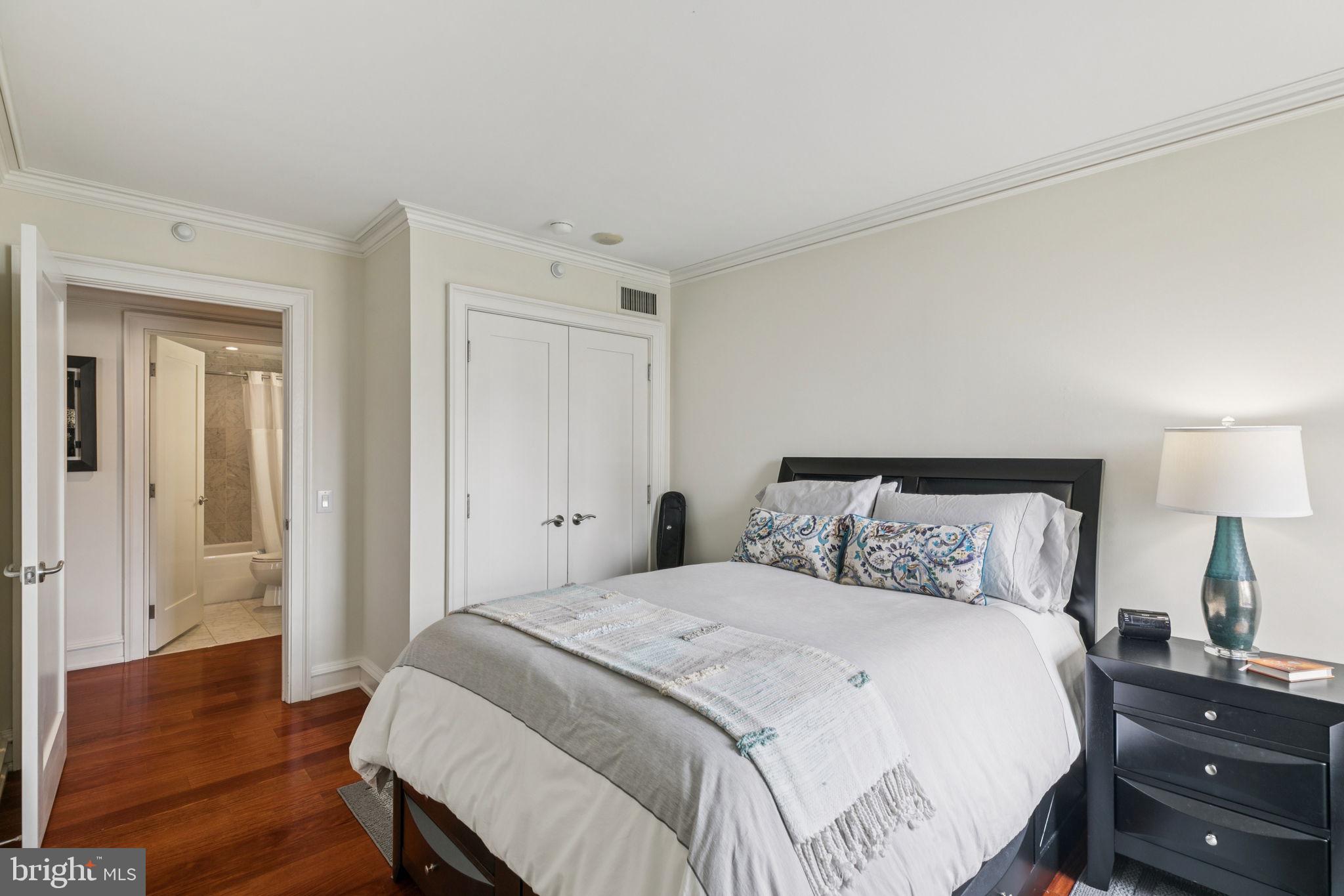 219 South 18th Street, Unit 1506 Philadelphia, PA 19103 - Photo 17 of 28 a bedroom with a bed and wooden floor