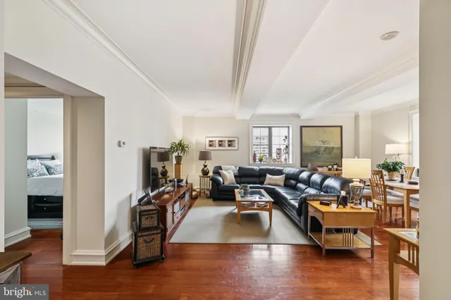 a living room with fireplace furniture and wooden floor