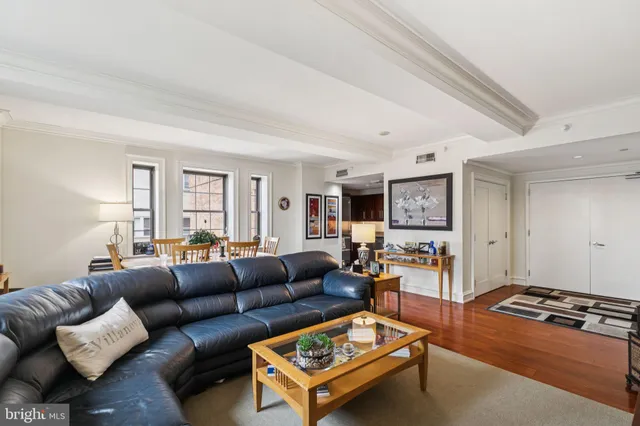 a living room with furniture a rug and a window