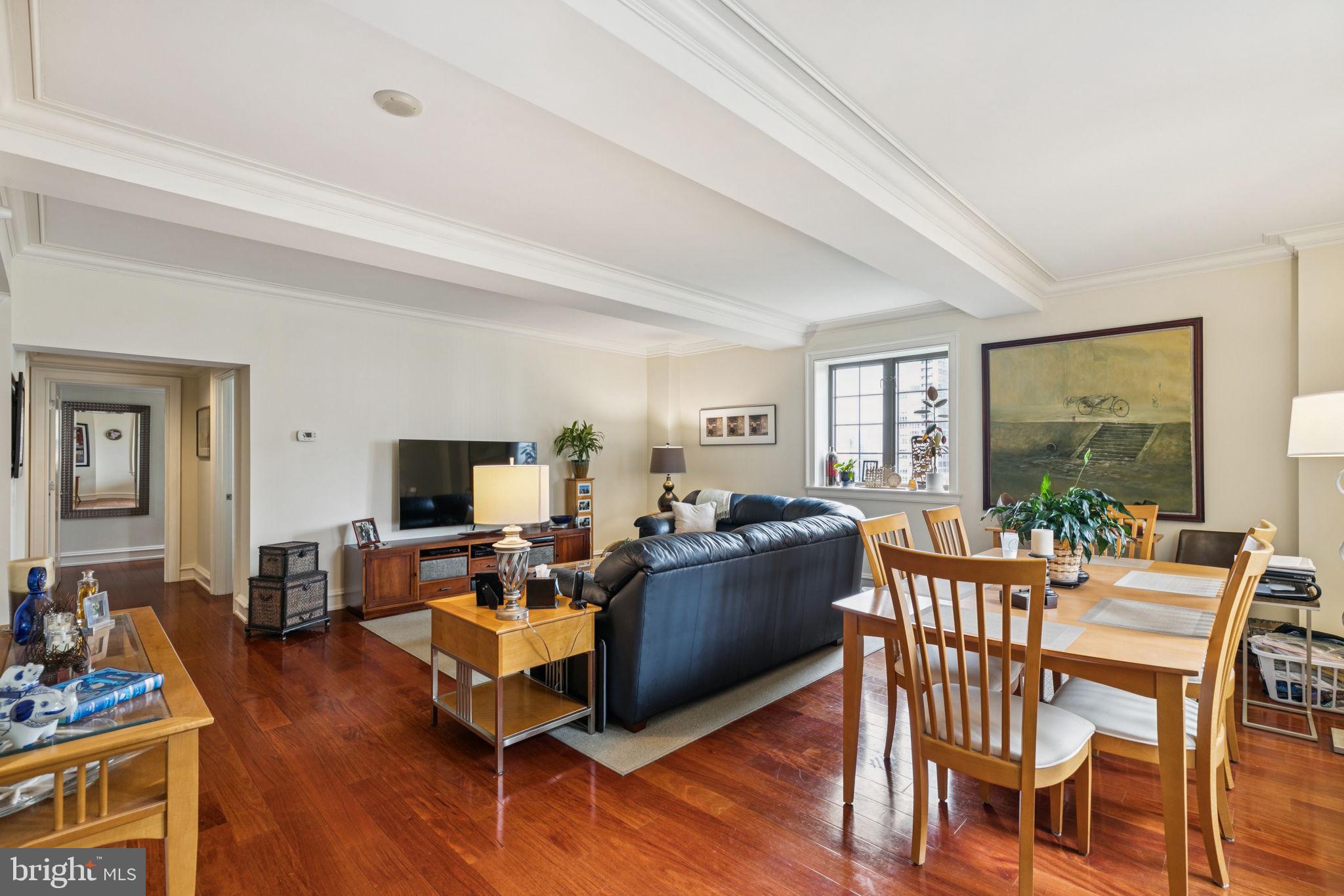 219 South 18th Street, Unit 1506 Philadelphia, PA 19103 - Photo 6 of 28 a living room with furniture a flat screen tv and wooden floor